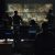 Group of people in dark room launching a missle Group of soldiers or spies in dark room with large monitors and advanced satellite communication technology launching a missle. Includes flashing yellow light.