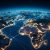 Planet Earth at night seen from space showing North America, South America, Africa, Europe, Asia and the Middle East connected in a global network, interconnected global community concept.